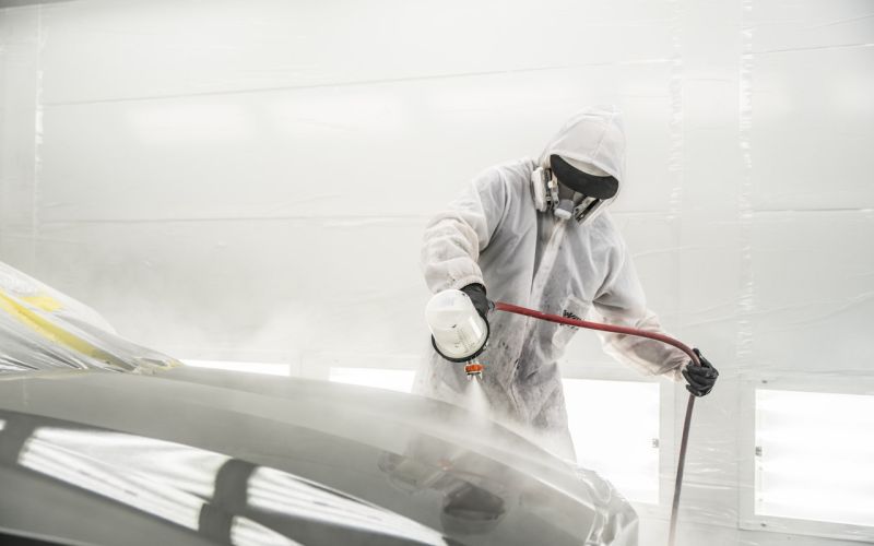 Painting a car in the painting booth.