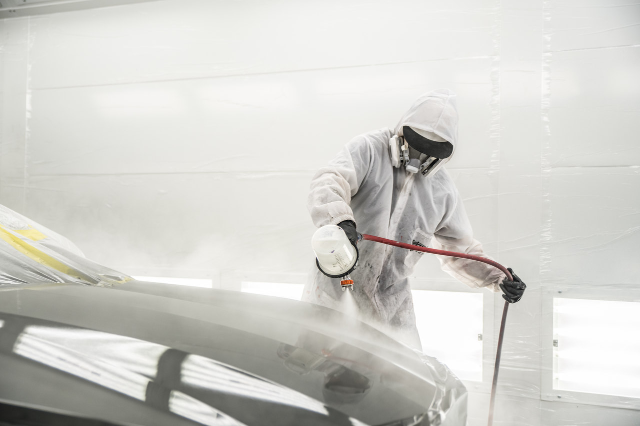 Painting a car in the painting booth.